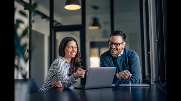 Smiling people, in the meeting room, using a laptop, searching s stock photo