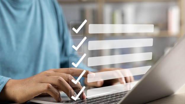 Business performance monitoring and evaluation concept, Take an assessment, Business man using laptop and tablet online checklist survey, Filling out digital checklist, Questionnaire with checkboxes.