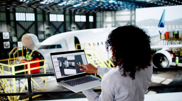 Airplane Maintenance At Airport. Woman Using Laptop
